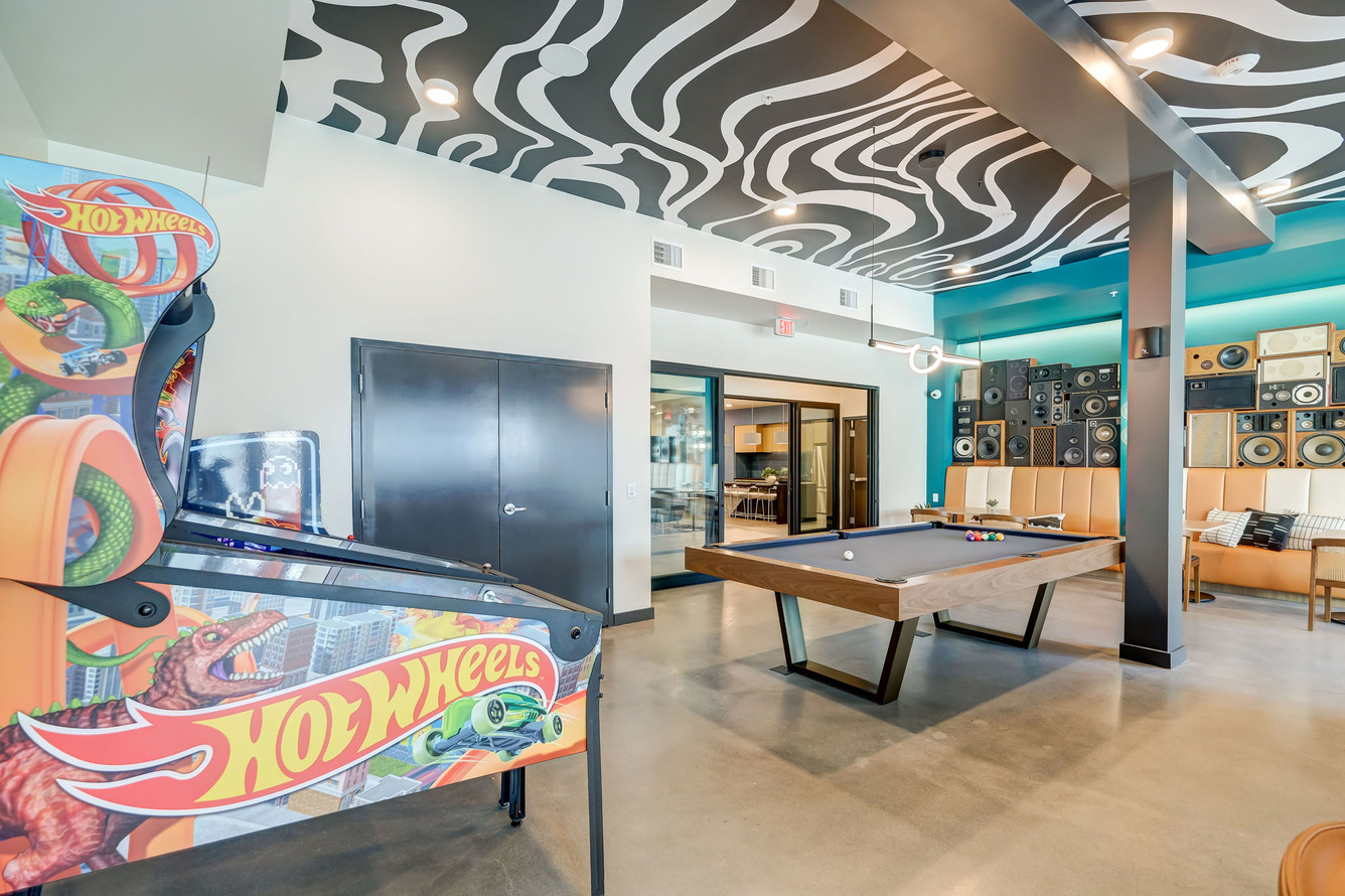 BoomCase Vintage Speaker Wall with bar pool table and arcades pinball machines. Interior Design