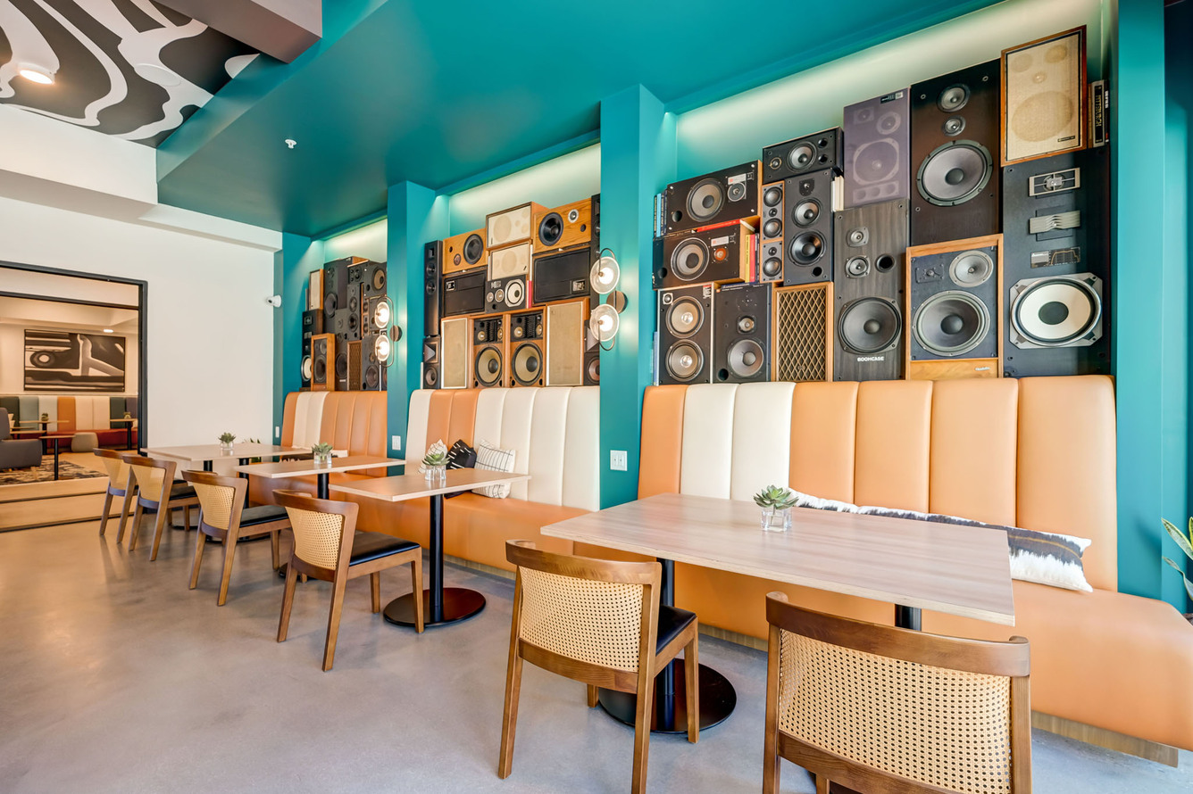 BoomCase Vintage Speaker Wall with bar pool table and arcades pinball machines. Interior Design