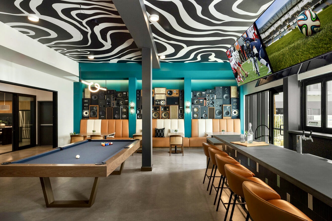 BoomCase Vintage Speaker Wall with bar pool table and arcades pinball machines. Interior Design